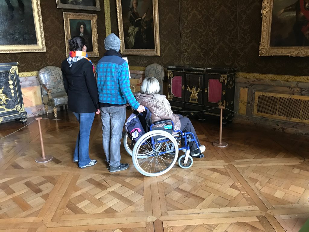 Accessibility Features of Versailles, person using wheelchair viewing interior of Versailles